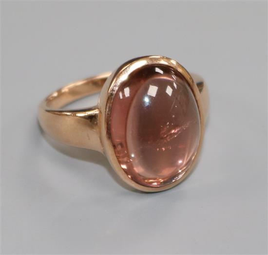 A 14k gold and cabochon pink gem ring, size Q/R.